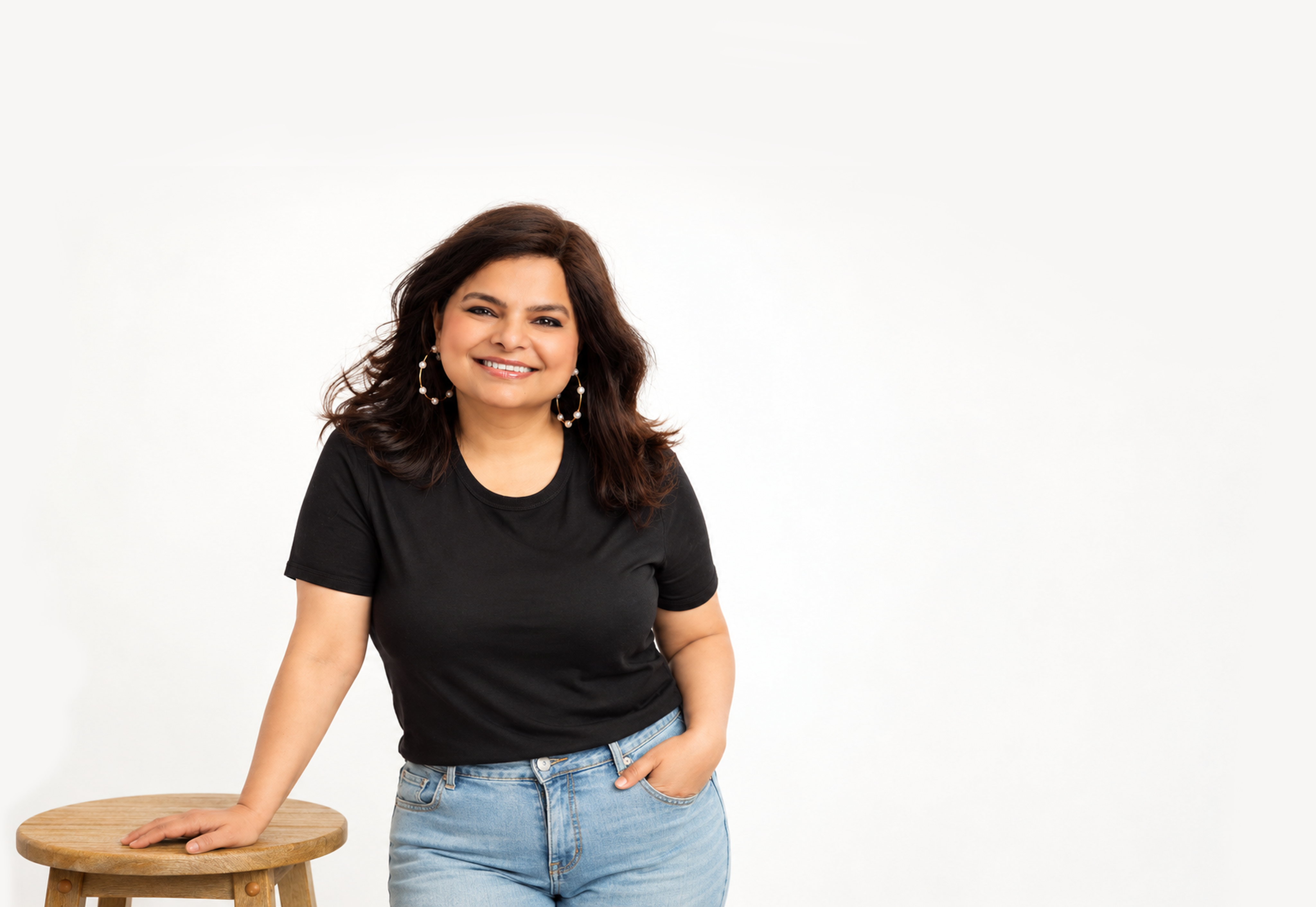 Pragya Tomar smiling beside a wooden stool