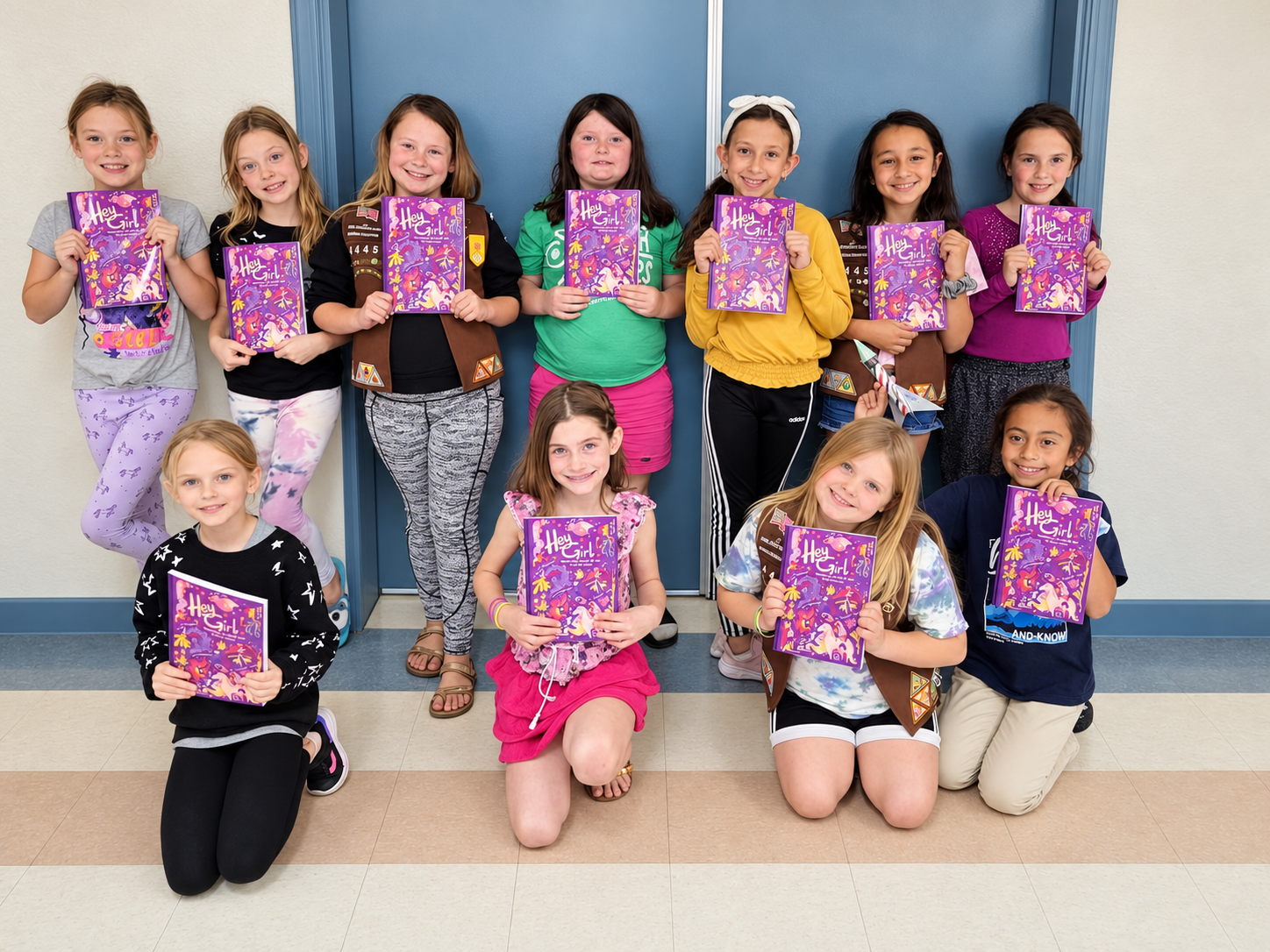 Students at a school in Michigan holding copies of Hey Girl